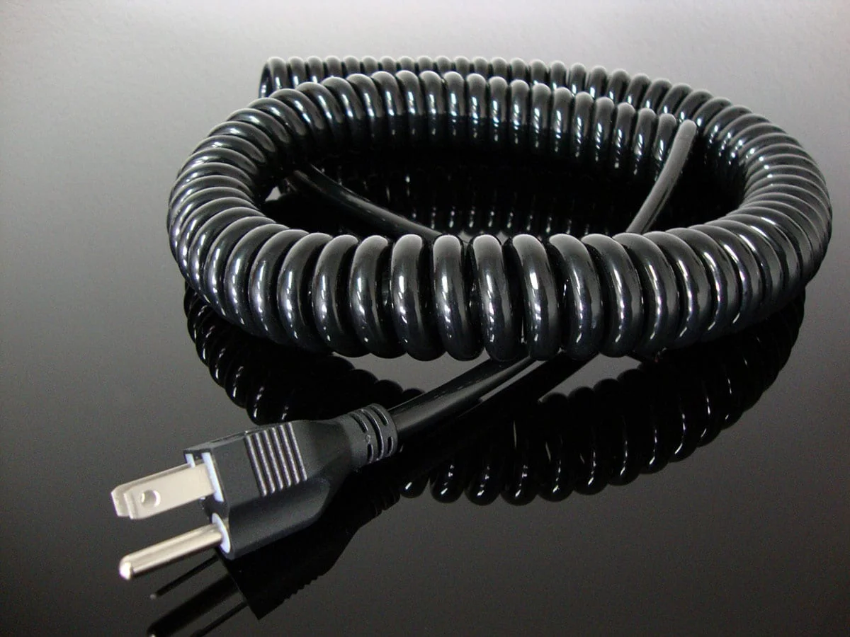Black curly power cord with molded three-prong plug
